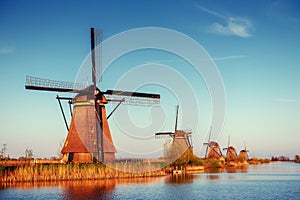 Colorful spring day with traditional Dutch windmills canal in Ro