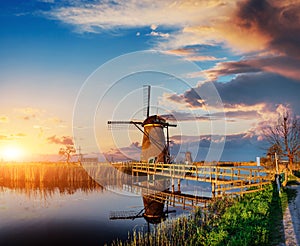 Colorful spring day with traditional Dutch windmills canal in Ro