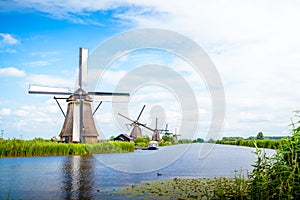 Colorful spring landscape in Netherlands, Europe. Famous windmills in Kinderdijk village in Holland. Famous tourist attraction in