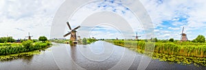 Colorful spring Panorama landscape in Netherlands, Europe. Famous windmills in Kinderdijk village in Holland.