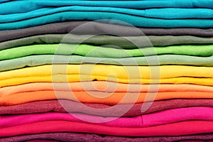 Colorful stack of t-shirts clothes texture background