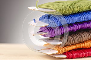 Colorful stacking cotton yarn wool over beautiful reverberation gradient background