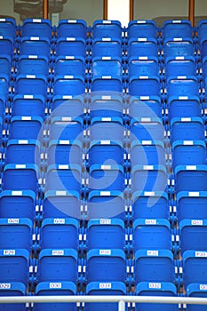 Colorful of stadium seats in background.