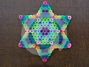 A colorful Star Of David on a wooden background