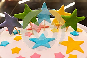 Colorful stars decorate the cake, close-up