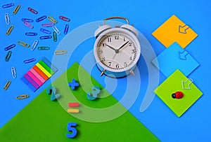 Colorful stationery on a blue monophonic background. Numbers and add-ons. teaching children math Mockup, space for text. Education