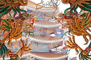 Colorful statue of Chinese dragon wrapped around the pillar. Beautiful statue of dragon carved around temple pole in Chinese