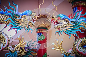 Colorful statue of Chinese dragon wrapped around red pillar. Beautiful statue of dragon carved around temple pole in Chinese