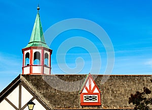 colorful steeple and dormer window on thatched roof