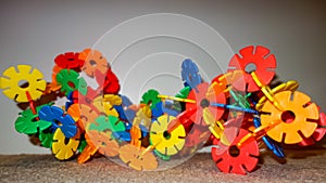 Colorful stick flowers arranged in an elaborate architecturally impressive top construction . Children\'s toys .