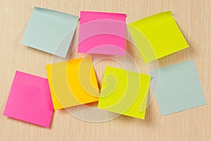 Colorful stickers on wooden board from notice