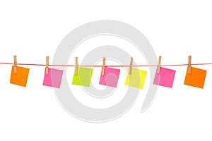 Colorful stickies hanged on red rope isolated