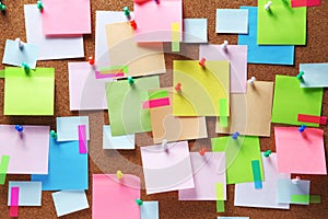 Colorful sticky notes on cork bulletin board