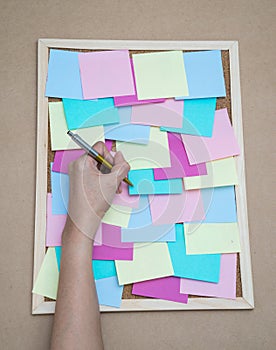 Colorful sticky notes on cork bulletin board