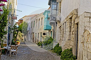 Colorful and stone houses in narrow street in Alacati cesme