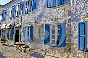 Colorful and stone houses in narrow street in Alacati cesme