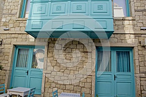 Colorful and stone houses in narrow street in Alacati cesme