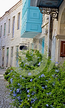 Colorful and stone houses in narrow street in Alacati cesme