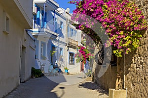 Colorful and stone houses in narrow street in Alacati cesme