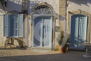 Colorful and stone houses in narrow street in Alacati cesme