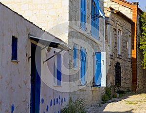 Colorful and stone houses in narrow street in Alacati cesme