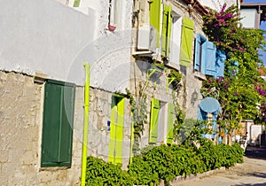 Colorful and stone houses in narrow street in Alacati cesme