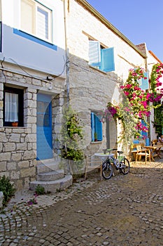 colorful and stone houses in narrow street in Alacati cesme