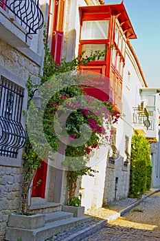 Colorful and stone houses in narrow street in Alacati cesme