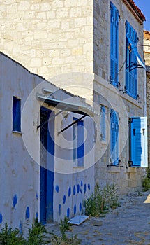 Colorful and stone houses in narrow street in Alacati cesme