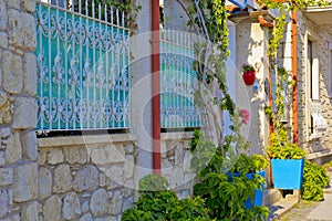 Colorful and stone houses in narrow street in Alacati cesme