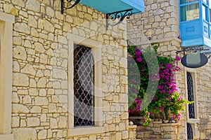 Colorful and stone houses in narrow street in Alacati cesme