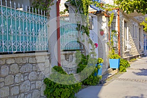 Colorful and stone houses in narrow street in Alacati cesme