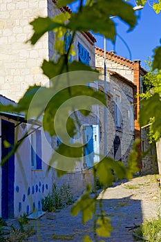 Colorful and stone houses in narrow street in Alacati cesme