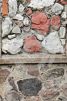 Colorful stone wall with many textures of cement