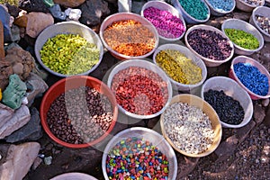 Colorful stones in clay vessels background