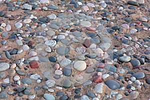 Colorful stones embedded in the sand bed