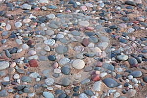 Colorful stones embedded in the sand bed photo