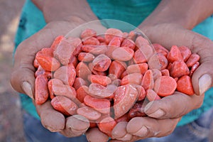 Colorful stones in hand background