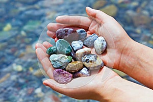 Colorful stones in hands
