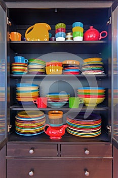 Colorful Stoneware Dinnerware in China Cabinet photo