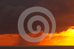 Colorful storm clouds with rain over Somosomo Strait on Taveuni