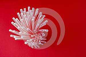 Colorful straw cocktail on a red background