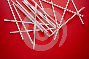 Colorful straw cocktail on a red background