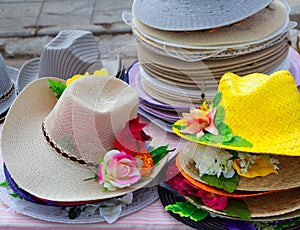 Colorful straw hats stacked in an outdoor