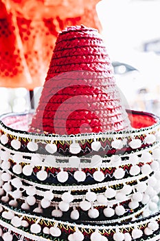 Colorful straw Mexican hats with white pompoms