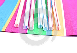 Colorful straws on colorful napkin. Plast and paper