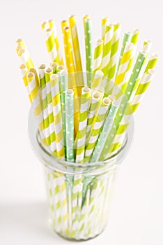 Colorful Straws Yellow and Green Straws in Glass White Background Vertical