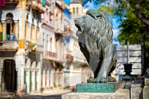 Colorful street in Old Havana with the bronze lion at El Prado