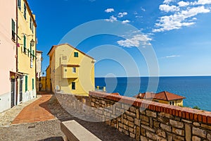 Colorful streets of mediterranian town with deep blue sky and se photo