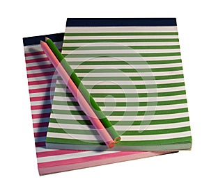 Colorful striped notepads and pencils